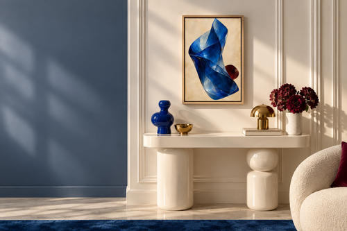 Cobalt Fold in a Natural float frame, 16 × 24 in, in a clean walnut and stone interior with sapphire upholstery; styled room visualisation.
